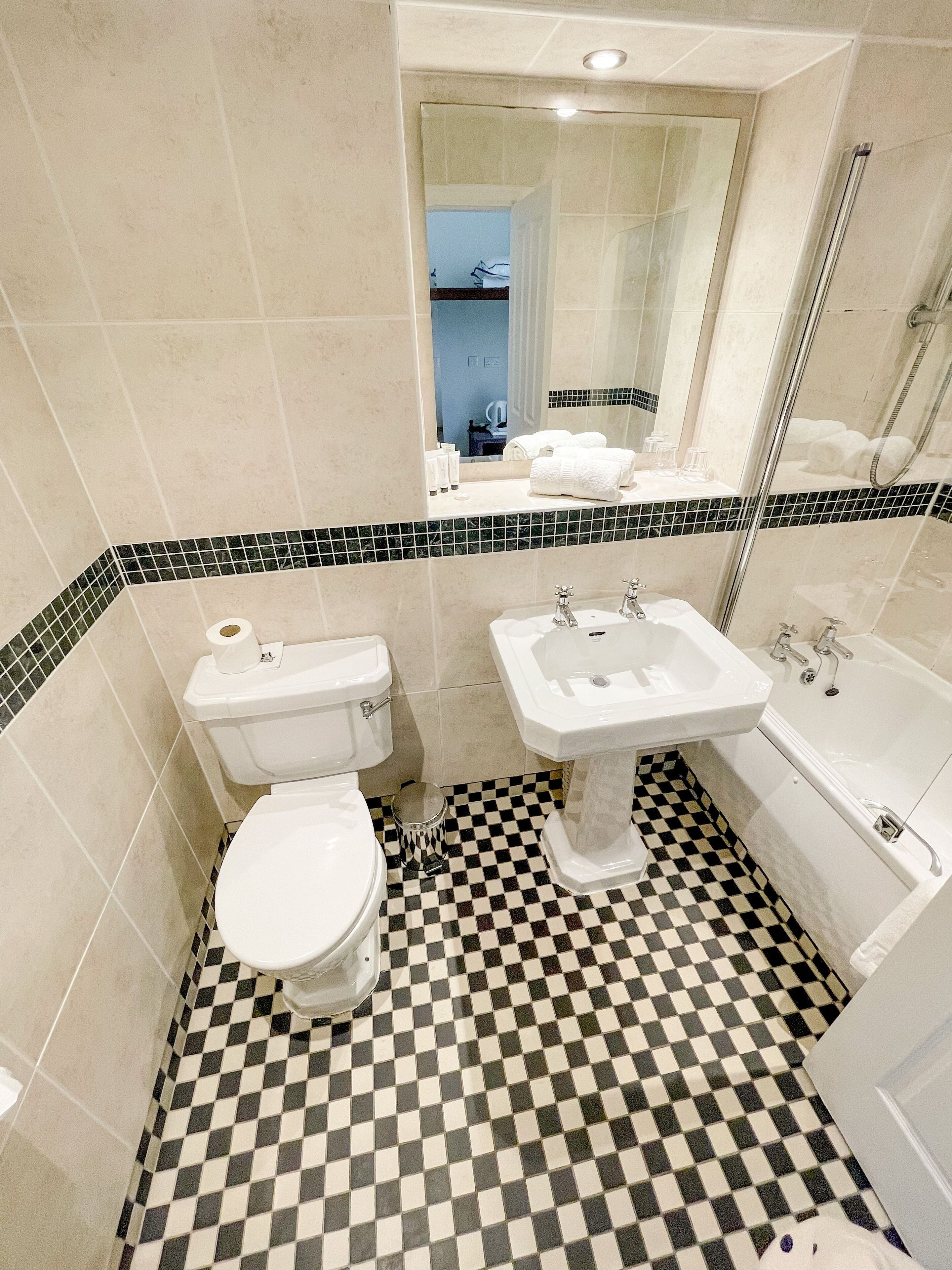 A bathroom with a toilet, sink, and bathtub.