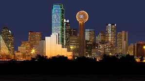 A city skyline at night with illuminated buildings and a distinctive spherical structure. - Crowne Plaza Dallas Market Ctr - Love Field by IHG (Dallas)