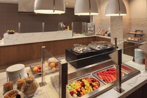 A buffet area with various food options, including fruits, cereals, and beverages. - Crowne Plaza Dallas Market Ctr - Love Field by IHG (Dallas)