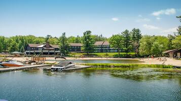 Guests can enjoy serene lakeside views and moored boats from the resort's tranquil surroundings.