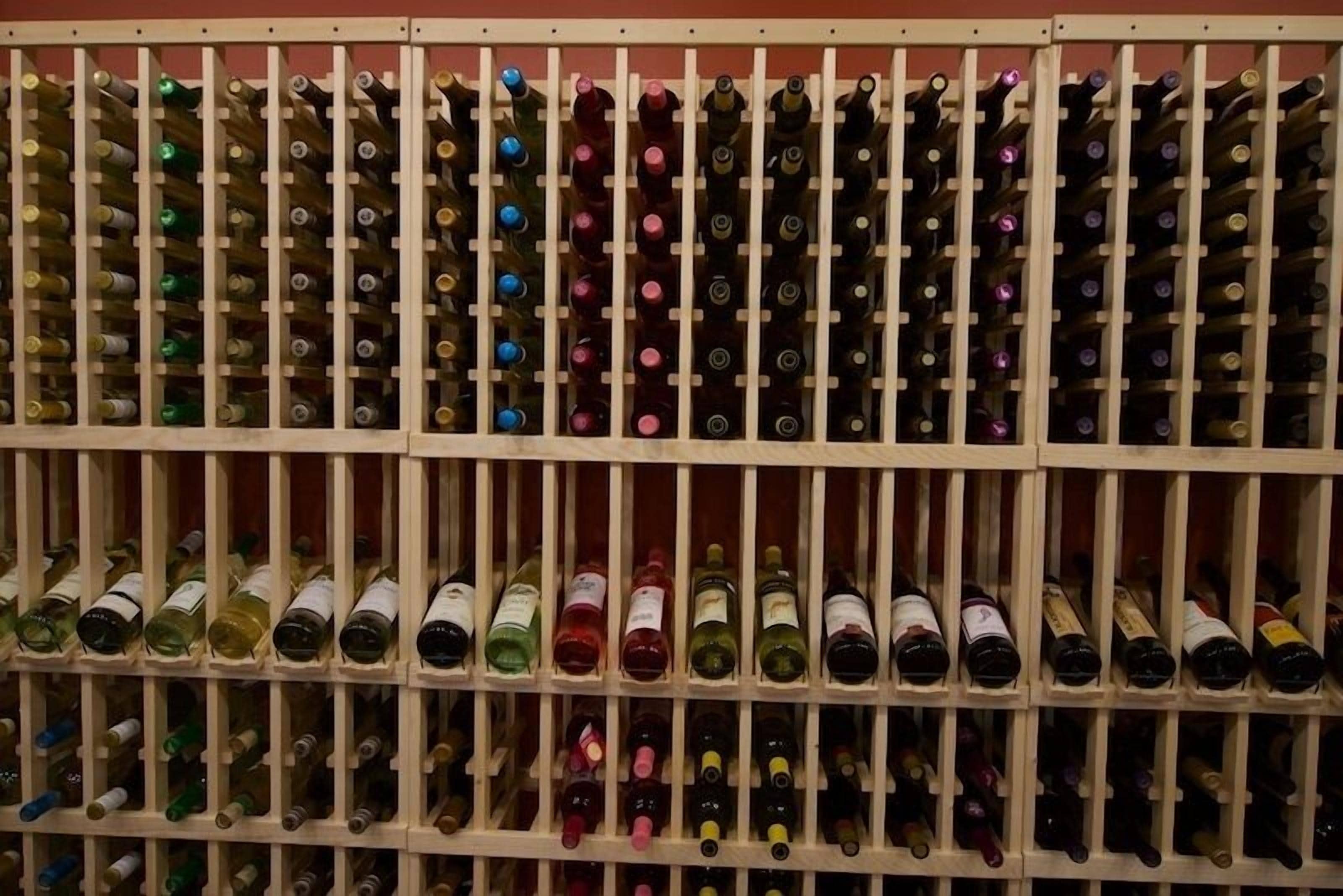 A wine rack with multiple rows and columns of wine bottles.