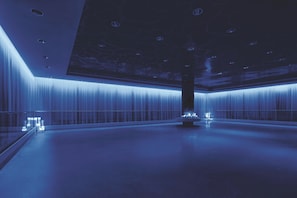 A spacious, modern interior with a high ceiling and a central column.
