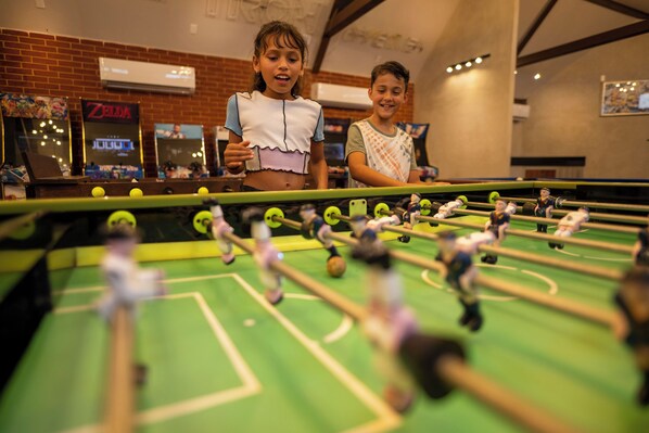 A foosball table in a room with brick walls and a neon sign. - Sunscape Cancun All-Inclusive Resort & Spa by Hyatt (Cancun)