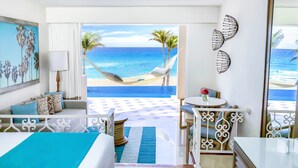 A hotel room with a bed, a desk, a chair, a view of the beach, and a hammock. - Sunscape Cancun All-Inclusive Resort & Spa by Hyatt (Cancun)
