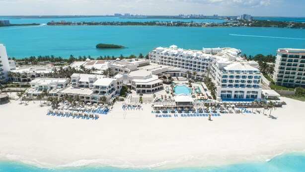 A resort with multiple buildings, a large pool, and a beach area with sun loungers. - Sunscape Cancun All-Inclusive Resort & Spa by Hyatt (Cancun)