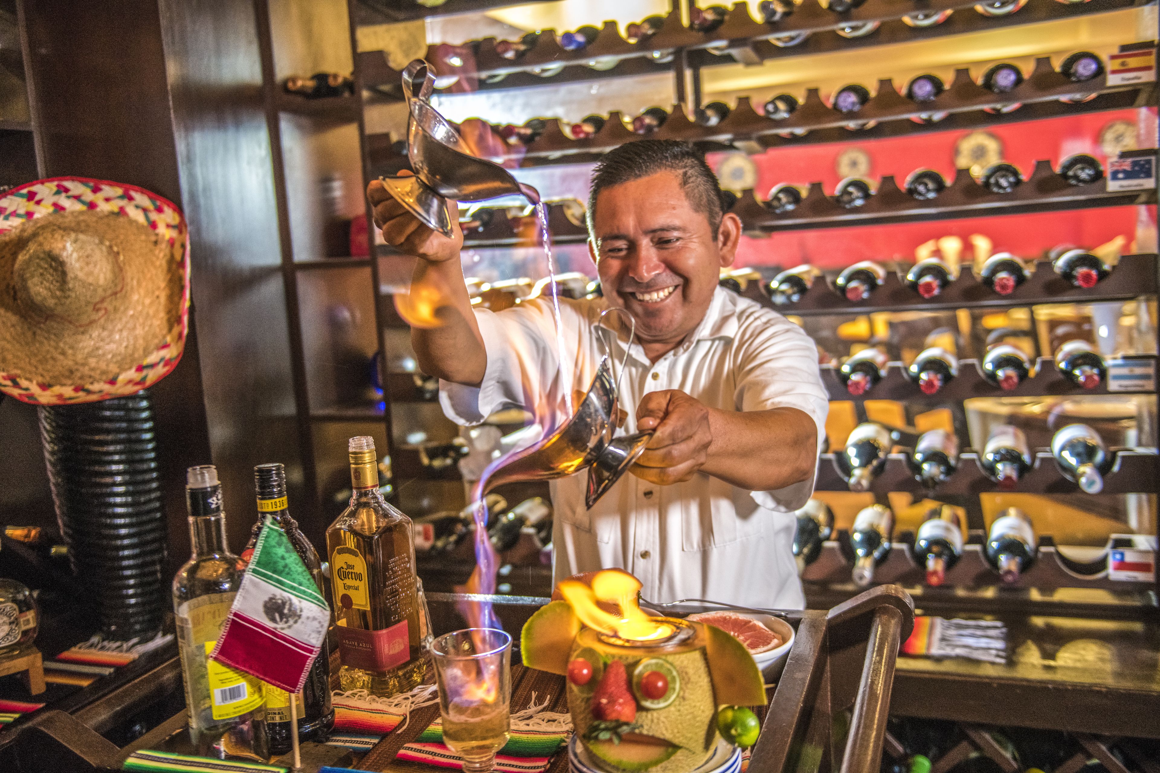 Un barman sirviendo una bebida en un vaso.