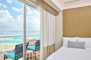 Enjoy breathtaking ocean views from the comfort of your room's spacious balcony, featuring a table and chairs.