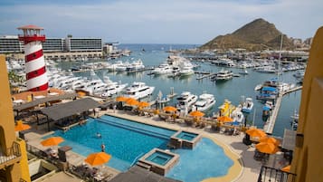 Enjoy waterfront views and a tranquil atmosphere by the marina, surrounded by a pool and sun loungers.