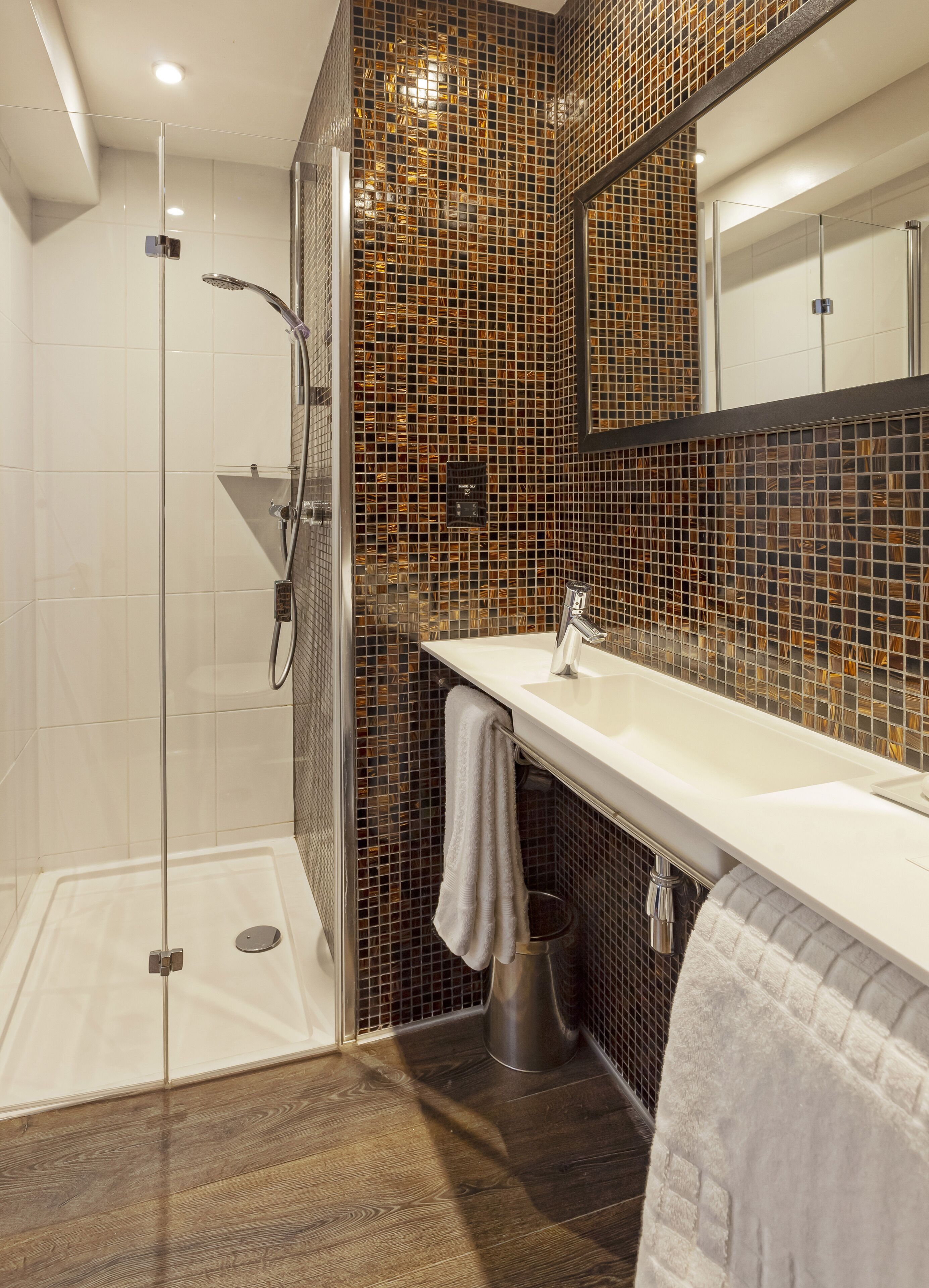 designer toiletries, hair dryer, slippers, towels