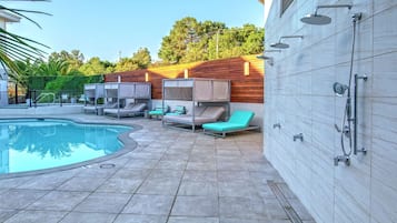 Relax by the pool surrounded by lounge chairs and a tiled deck.