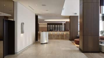 A modern kitchen with a central island, a bar area, and a seating space.