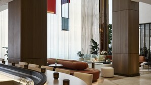 Un espace lounge moderne doté d’un bar incurvé, de sièges confortables et de grandes fenêtres.