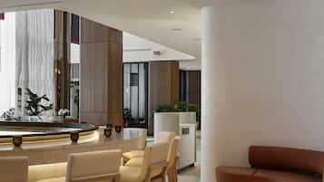 A modern interior with a bar area, seating, and a large window.