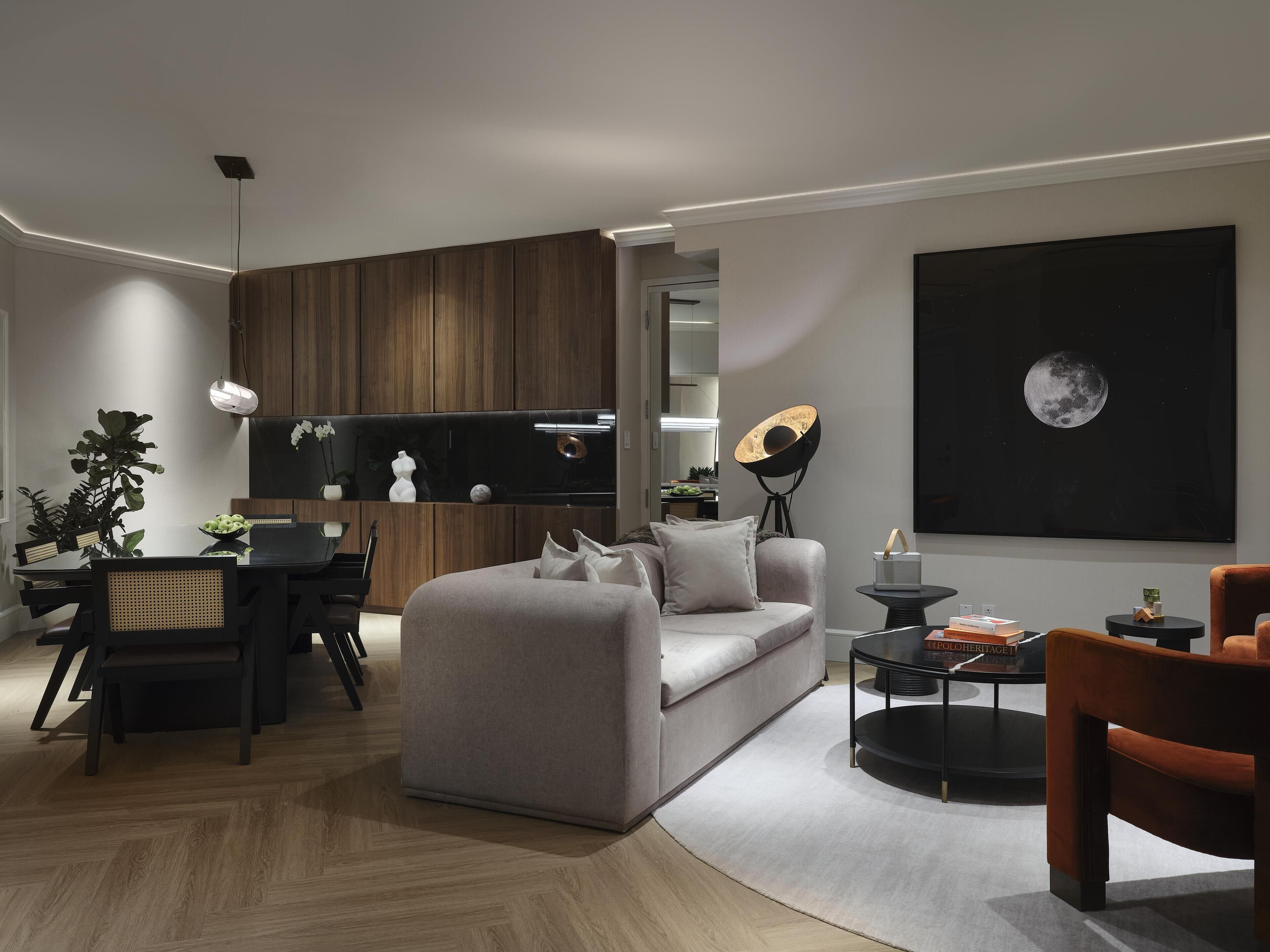 A modern living room with a sofa, coffee table, and dining area.