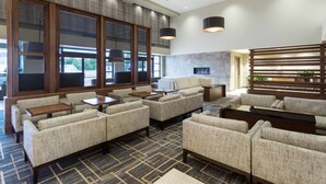 A modern lounge area with sofas, tables, and a fireplace. - Santa Ynez Valley Marriott (Buellton)