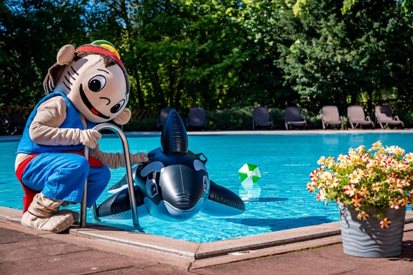 A person in a blue costume near a pool with a large inflatable orca. - AHORN Harz Hotel Braunlage (Braunlage)