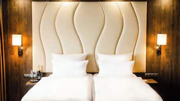 Ein Hotelzimmer mit einem großen Bett, zwei Nachttischen und Wandleuchten.