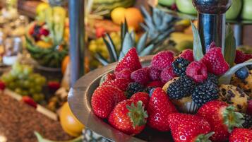 A metal tray filled with strawberries, raspberries, blackberries, and blueberries.