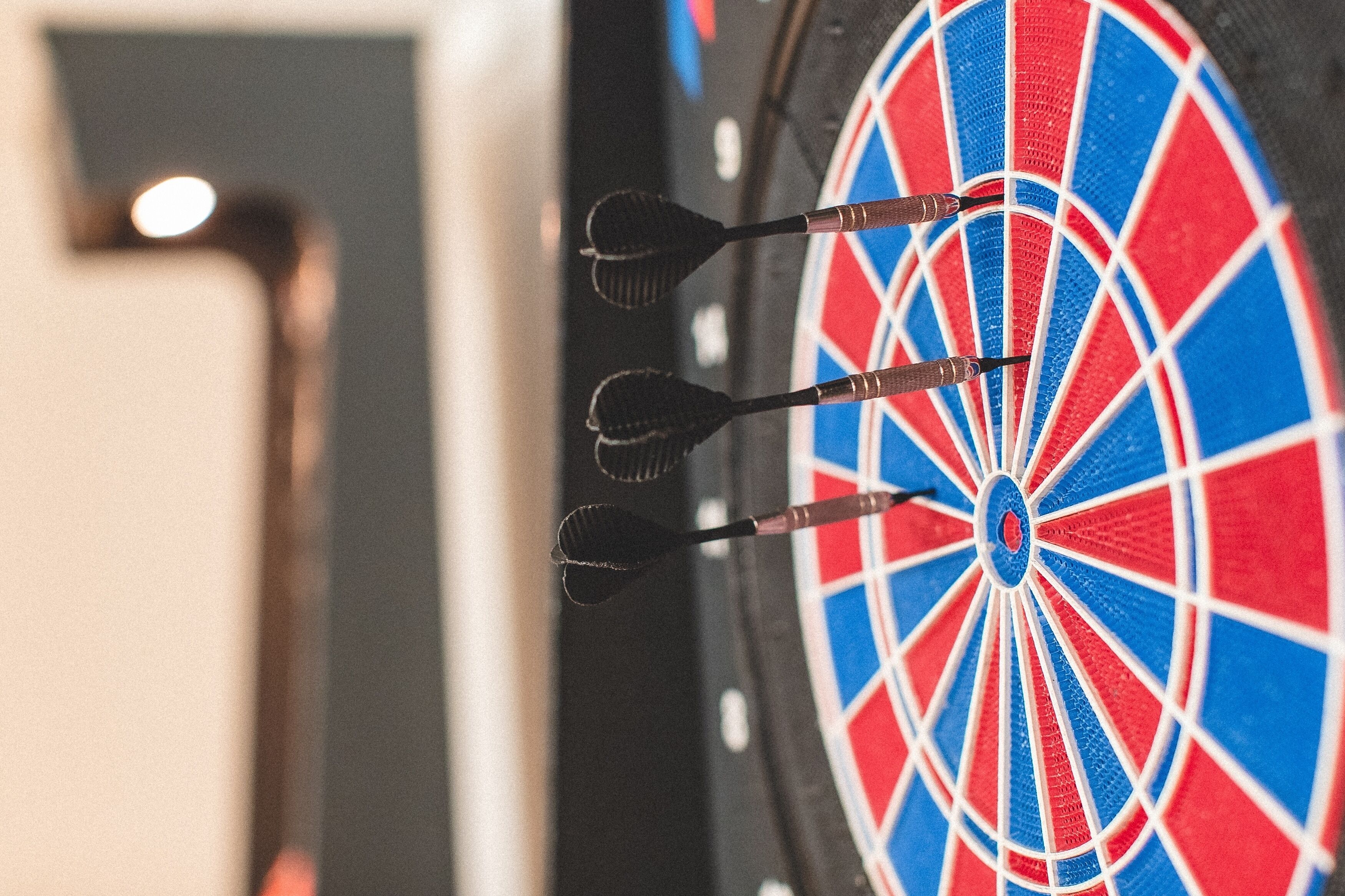 A dartboard with three darts in the center.