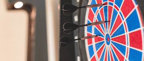A dartboard with three darts in the center.