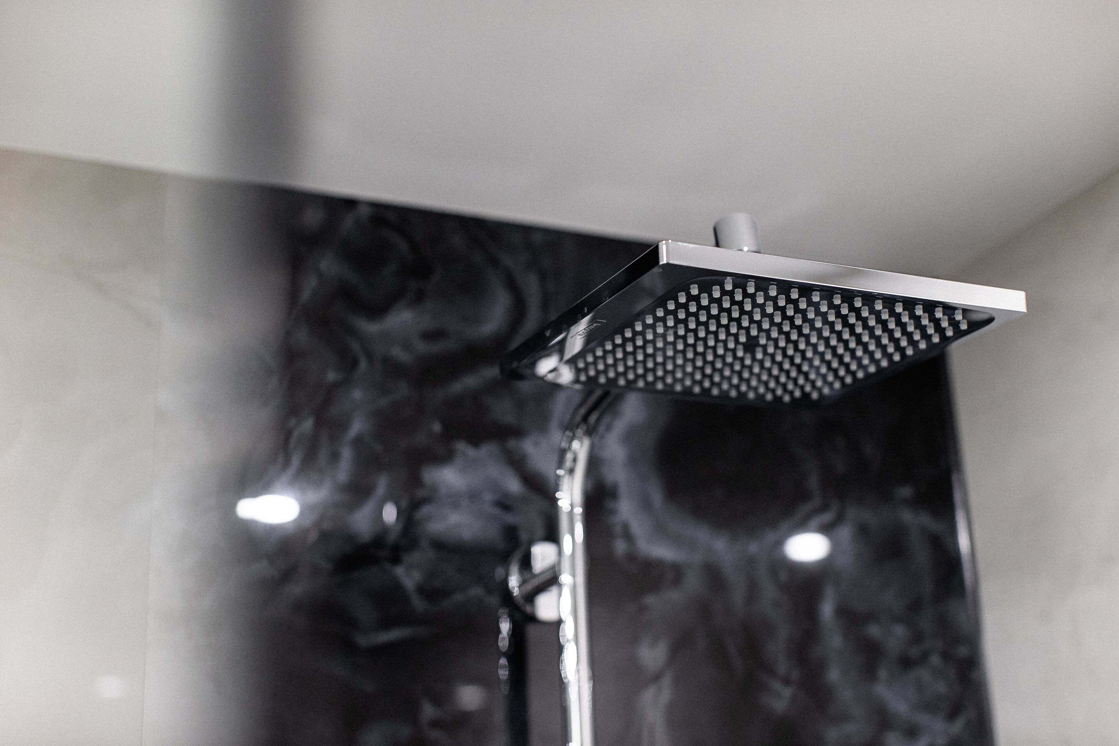 A modern showerhead with a square design and multiple nozzles.
