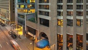 A high-rise building with multiple floors, large windows, and a prominent glass facade. - Metropolitan Hotel Vancouver by Marriott (Vancouver)
