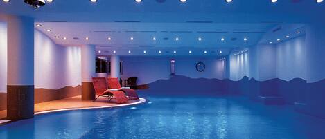 Indoor pool, pool umbrellas, pool loungers