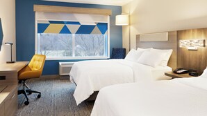 A hotel room with two beds, a desk, a chair, and a window with a view of trees. - Holiday Inn Express Hyannis Cape Cod by IHG (Hyannis)