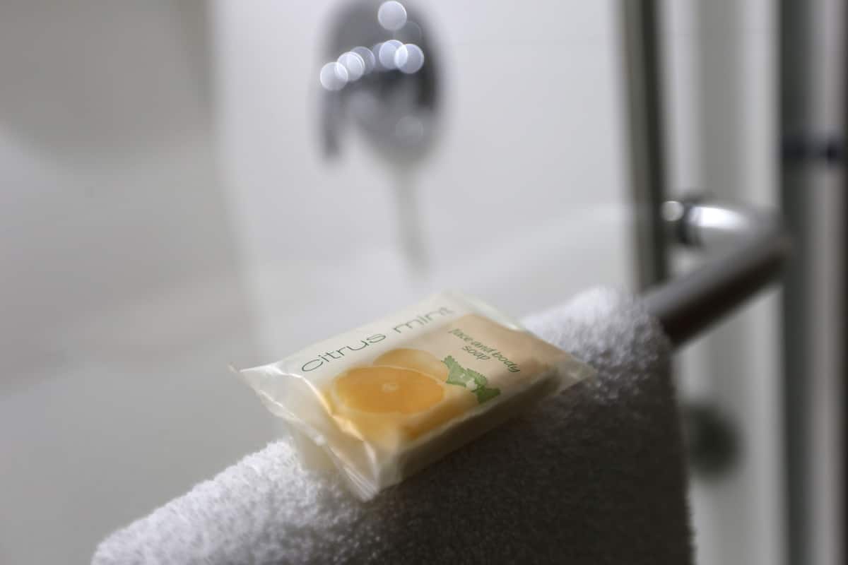 A bar of citrus mint soap on a towel.