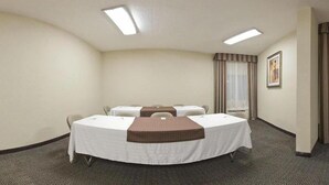 A conference room with a round table, four chairs, two small tables, and a brown accent table. - Holiday Inn Express Biloxi - Beach Blvd by IHG (Biloxi)