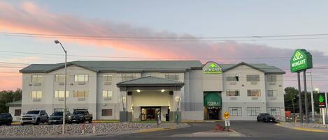 A hotel with a green sign reading "Wingate by Wyndham" and a "Tequila's" sign.