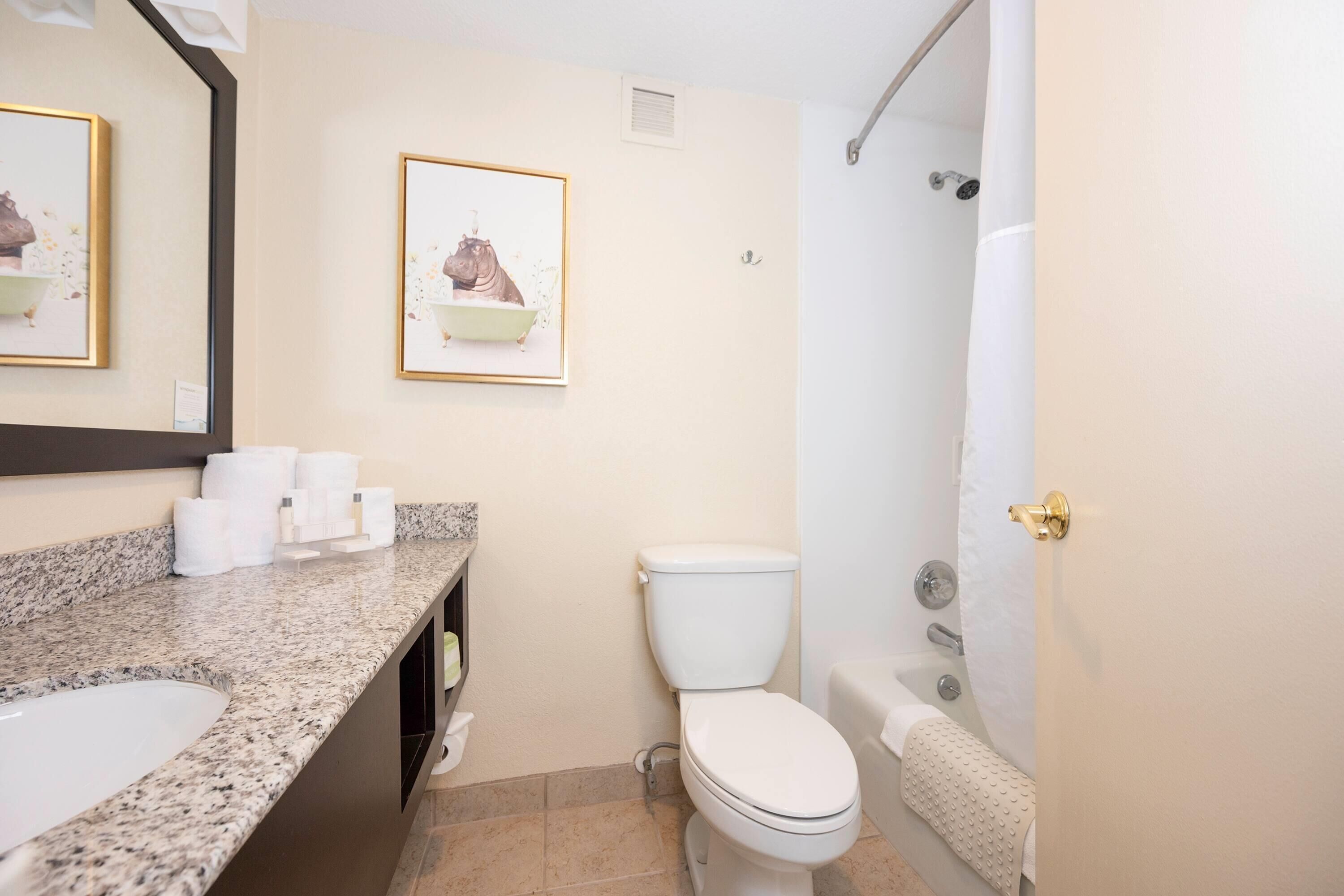 A bathroom with a sink, toilet, and bathtub.