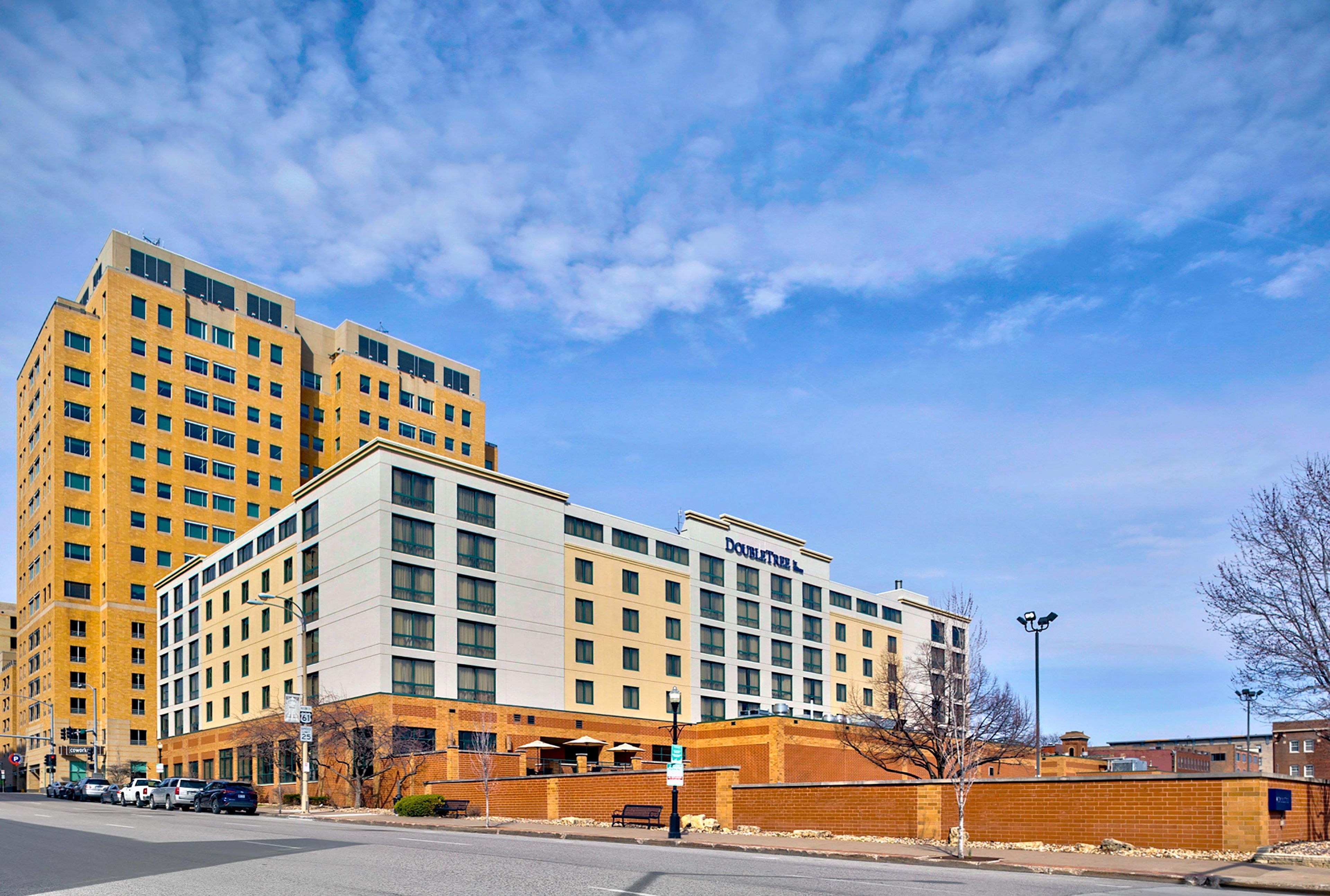 A hotel with a modern design, featuring multiple floors and a prominent entrance.