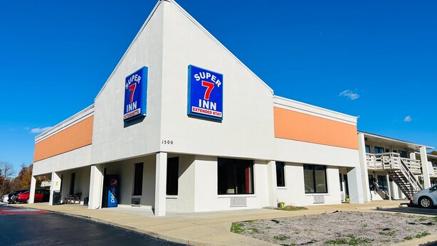 A 7 Inn Extended Stay hotel with a modern design, featuring a prominent 7 Inn logo on the facade.