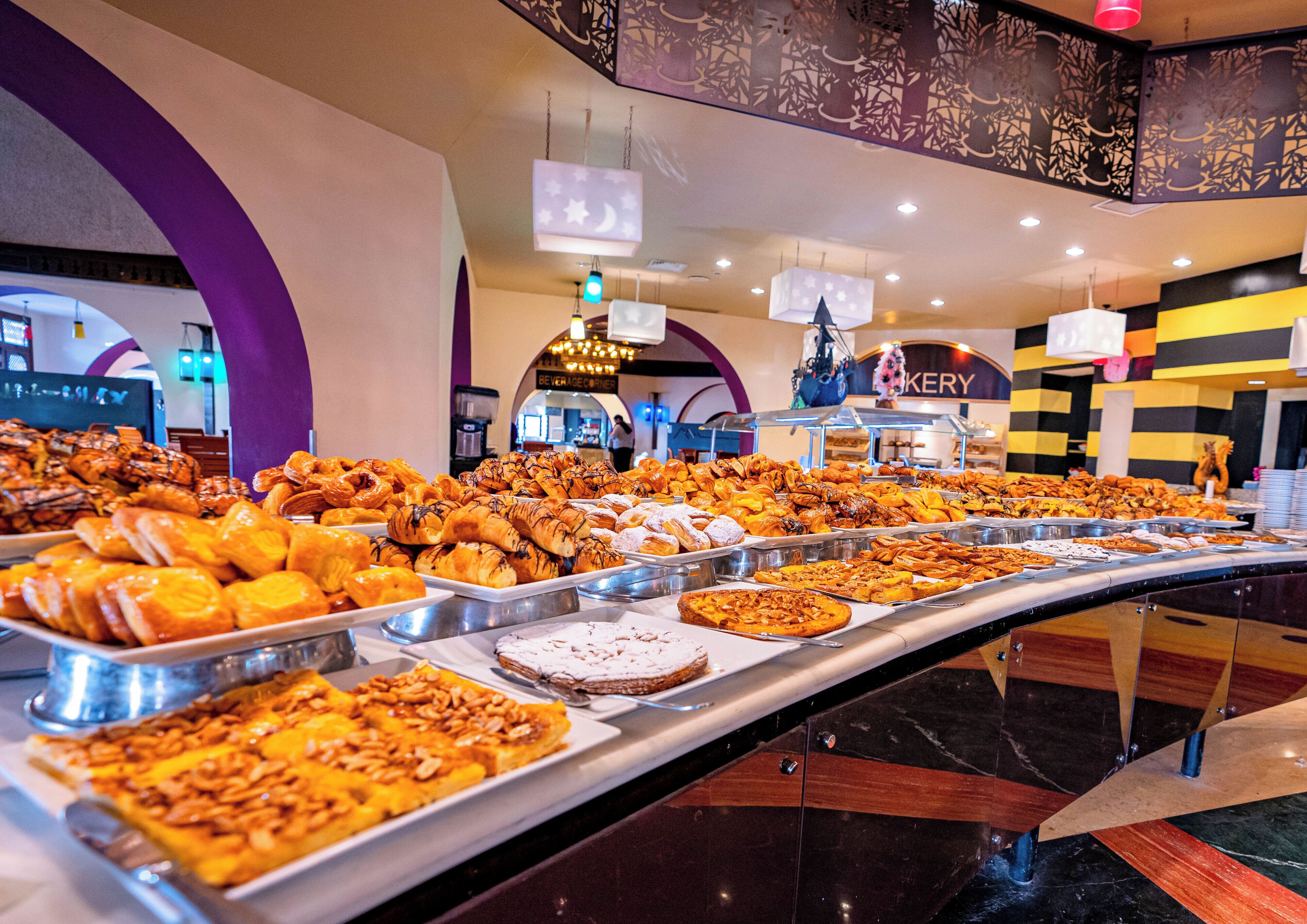 A buffet with various pastries and desserts.