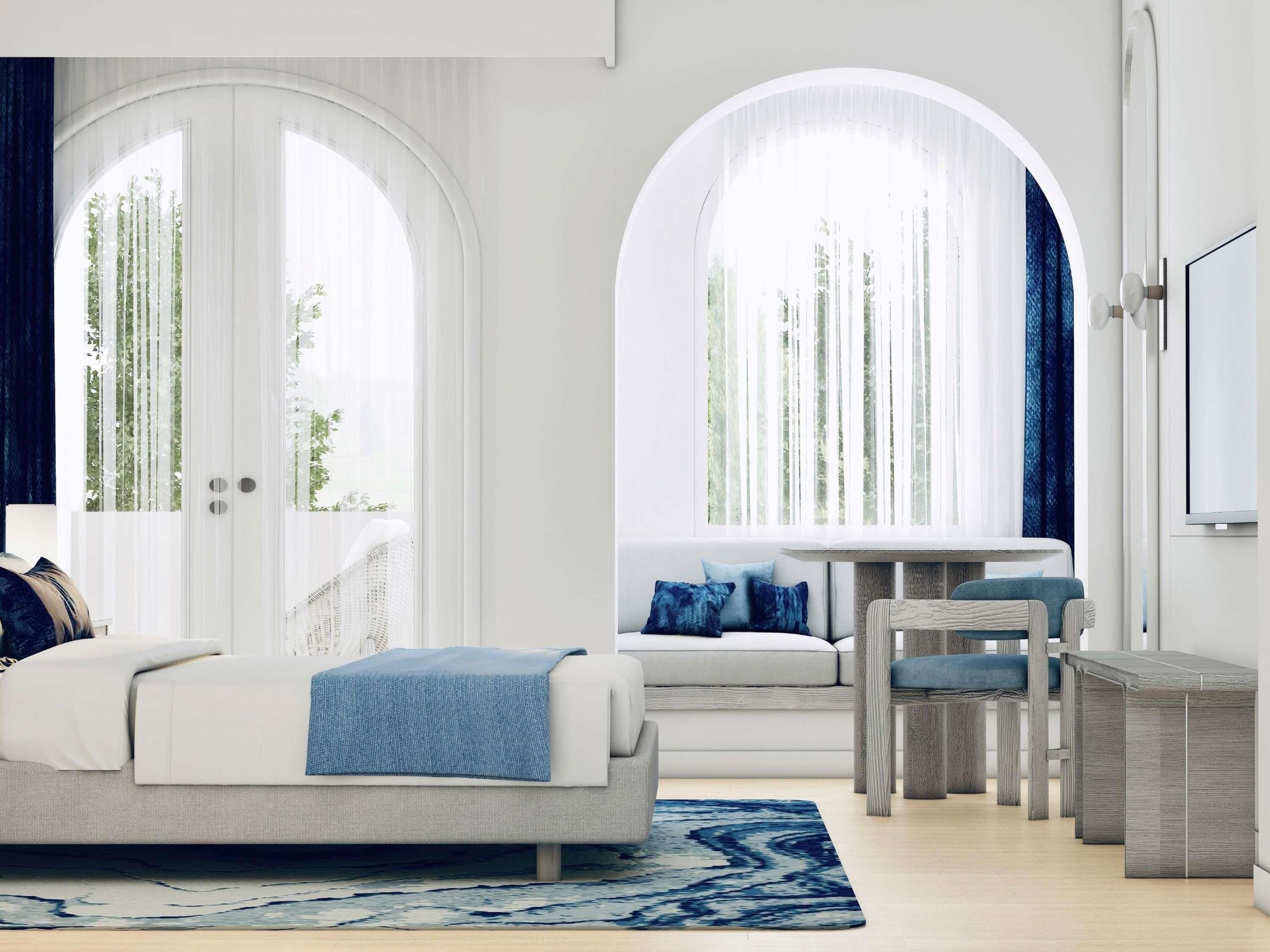 A modern living room with a sofa, a coffee table, and a dining area with chairs. There are large windows with curtains, a flat-screen TV mounted on the wall, and a patterned rug on the floor.
