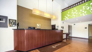 A reception desk with a sign reading "Sleep Invasions" and a "Welcome" mat.
