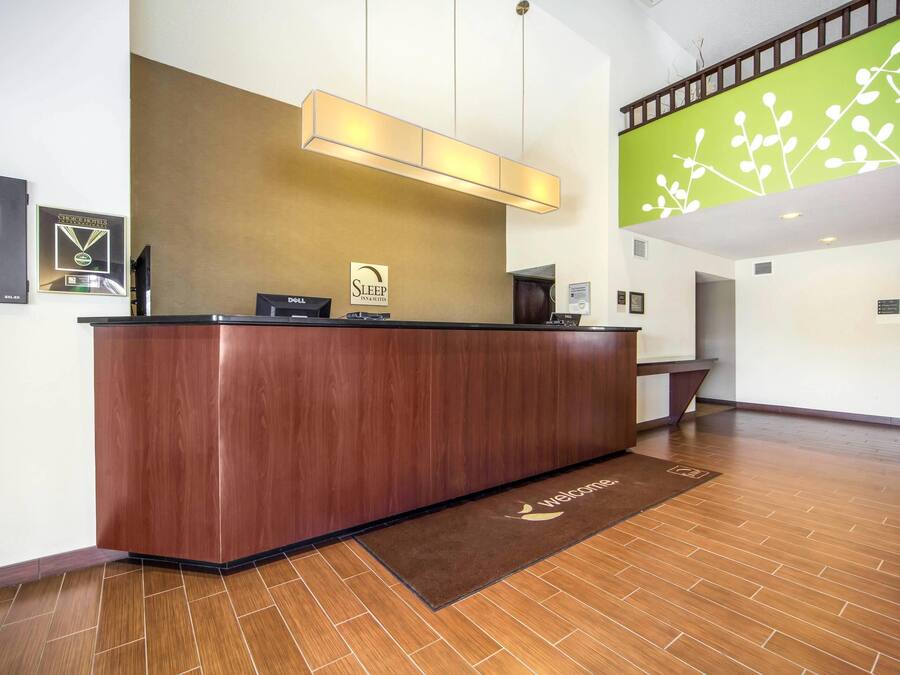A reception desk with a sign reading "Sleep Invasions" and a "Welcome" mat.