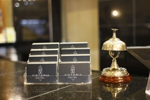 A display of hotel name cards and a trophy on a reflective surface. - The Victoria Hotel Manchester by Compass Hospitality (Oldham)