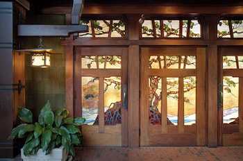 A large hotel with multiple buildings, a well-maintained lawn, and a pond. at The Lodge at Torrey Pines