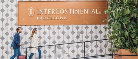 A sign for Intercontinental Barcelona with a geometric patterned wall in the background.