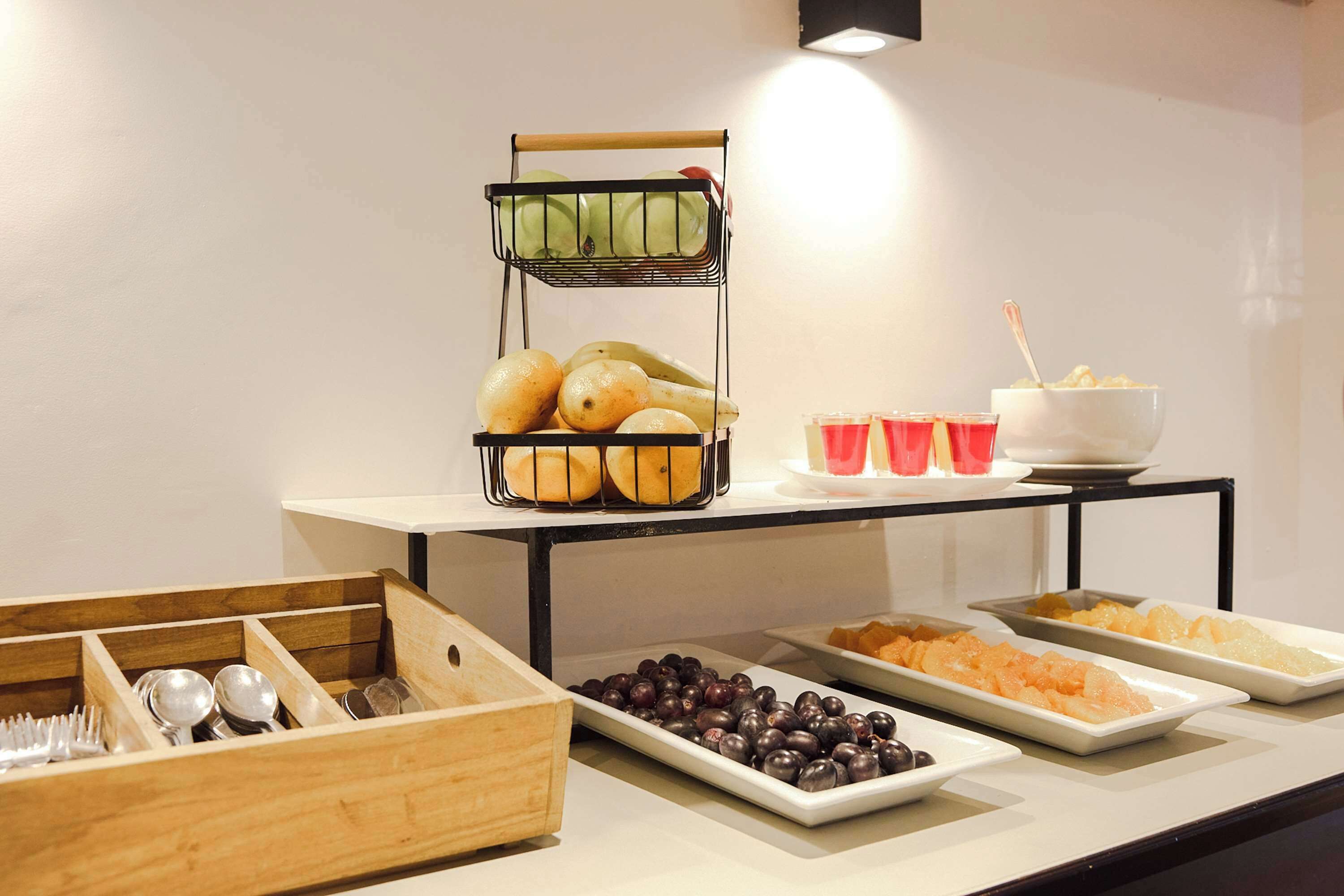 A buffet setup with various food items and utensils.