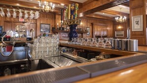 A bar area with a beer tap, glasses, and a cash register. - Hawthorne Hotel (Salem)