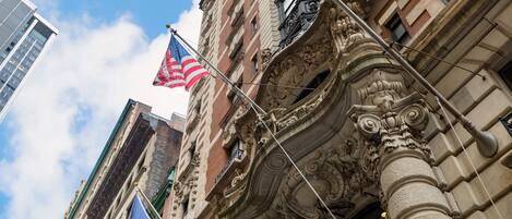 A historic building with ornate architectural details, including a prominent column and decorative moldings.
