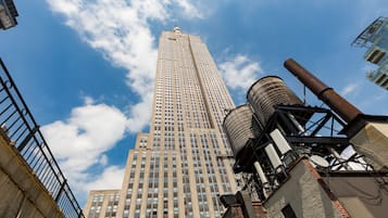 A tall building with a clear sky and clouds.