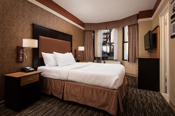 A gym with treadmills, elliptical machines, and weightlifting equipment. at The Hotel @ Fifth Avenue