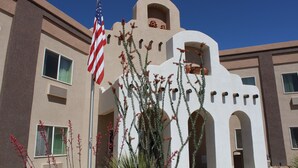 A building with a modern architectural style, featuring arched windows and a central tower.
