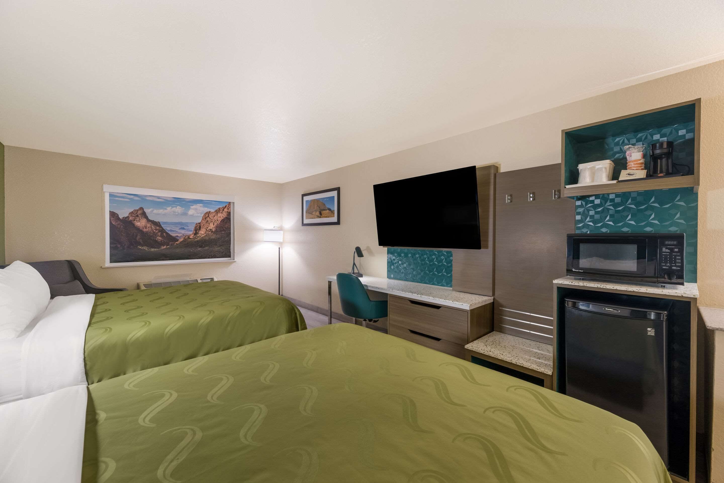 pillow-top beds, desk, laptop workspace, blackout curtains