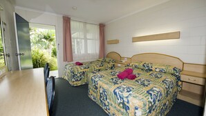 A hotel room with two beds, a wooden desk, a small bedside table, and a window with curtains. - Colonial Court Motor Inn (Kempsey)