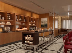 A modern kitchen with a bar area, equipped with various kitchen appliances and utensils. - Hôtel Le Morgane (Chamonix-Mont-Blanc)